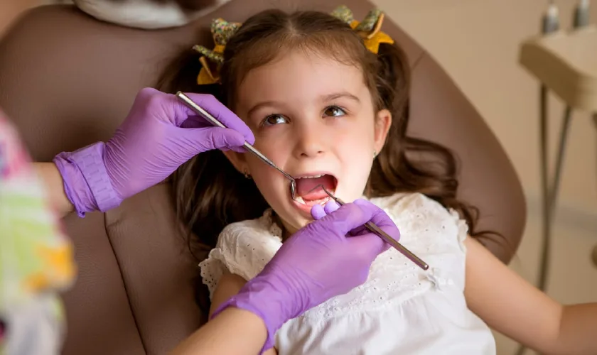child receiving a preventive fluoride treatment at Hometown Family Dental in Springdale AR child receiving a preventive fluoride treatment at Hometown Family Dental in Springdale AR
