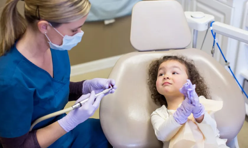 toddler smiling during a first dental visit at Hometown Family Dental in Springdale AR toddler smiling during a first dental visit at Hometown Family Dental in Springdale AR